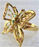 Butterfly with gemstones inserted into an 18-karat gold ring seen from the side