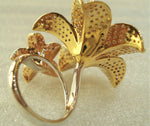 gold avatar ring with flowers filled with diamonds  rear behind