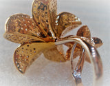 gold avatar ring with flowers filled with diamonds  rear behind with detailsd