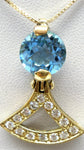 Natural blue topaz set as a pendant in an 18k gold and diamond necklace