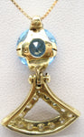 Natural blue topaz set as a pendant in an 18k gold and diamond necklace rear behind