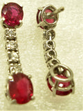 Burmese rubies set in an 18-karat gold earring with diamonds rear behind