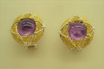 Cabochon amethyst set in an 18-karat gold earring chiseled by hand