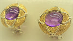 Cabochon amethyst set in an 18-karat gold earring chiseled by hand