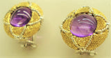 Cabochon amethyst set in an 18-karat gold earring chiseled by hand with details 