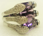 Amethyst ring set with 6 snake mouths filled with brilliants viewed from the side